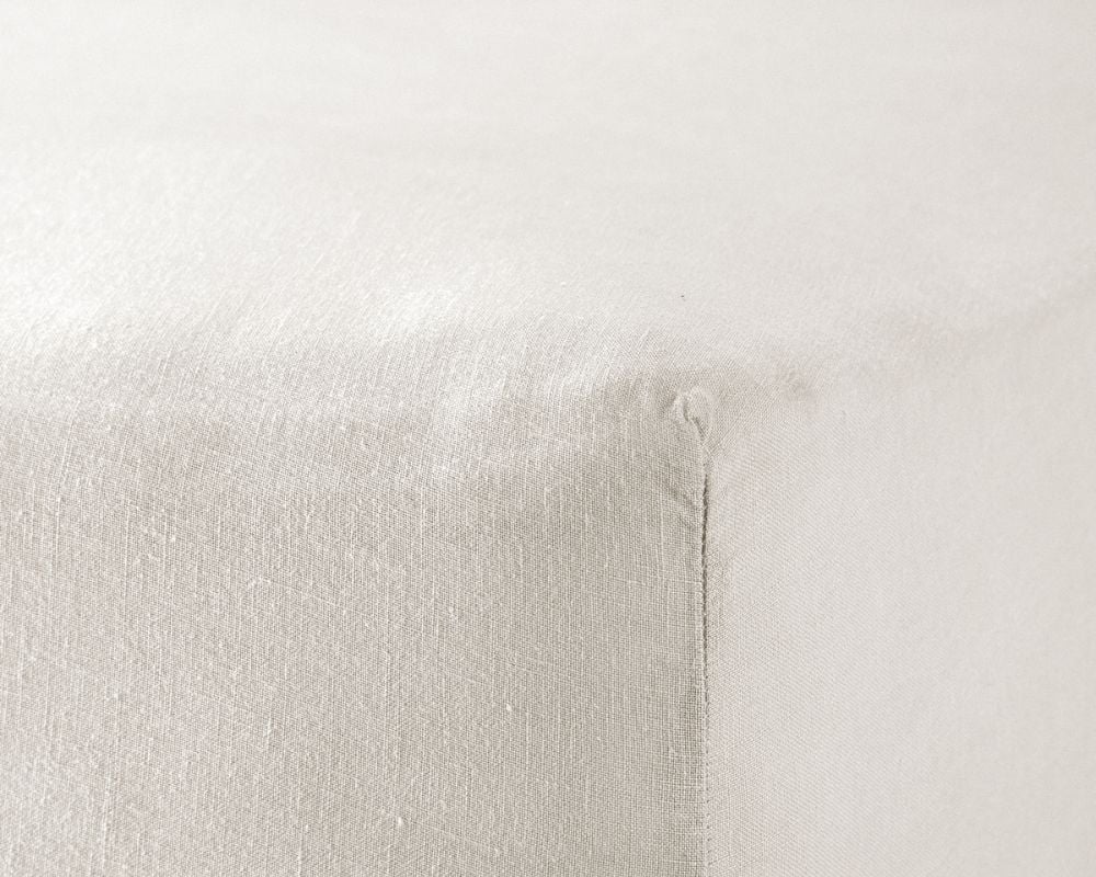 Close-up of a textured white pillow on a light gray background