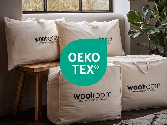 Woolroom pillows and bags with OEKO-TEX logo on a neutral background