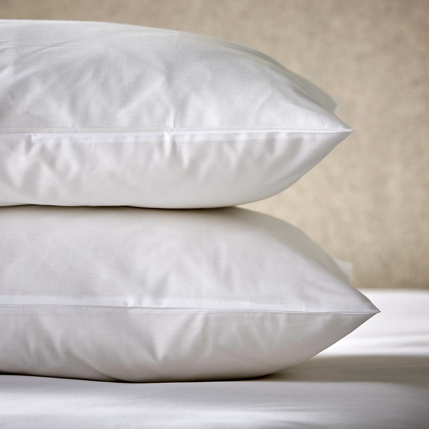 The Arinta Organic Cotton Body Pillow Case in white shown on two double stacked pillows.