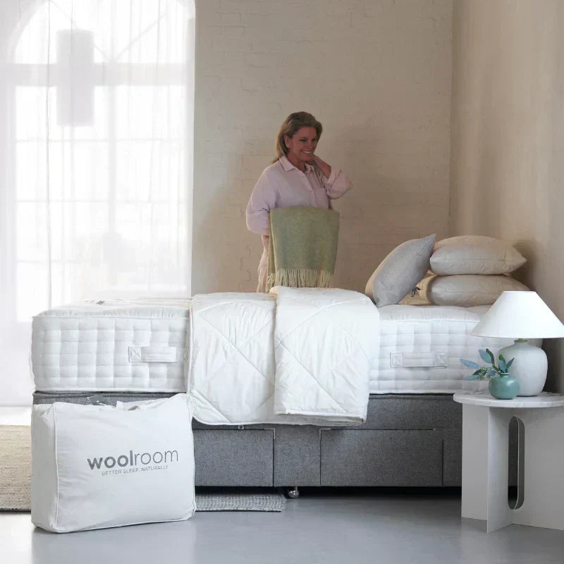 Lady standing in bedroom with woolroom products