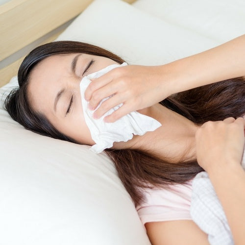 women blowing her nose