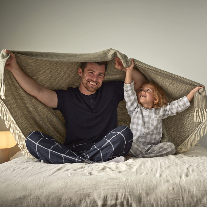father and daughter under a blanket