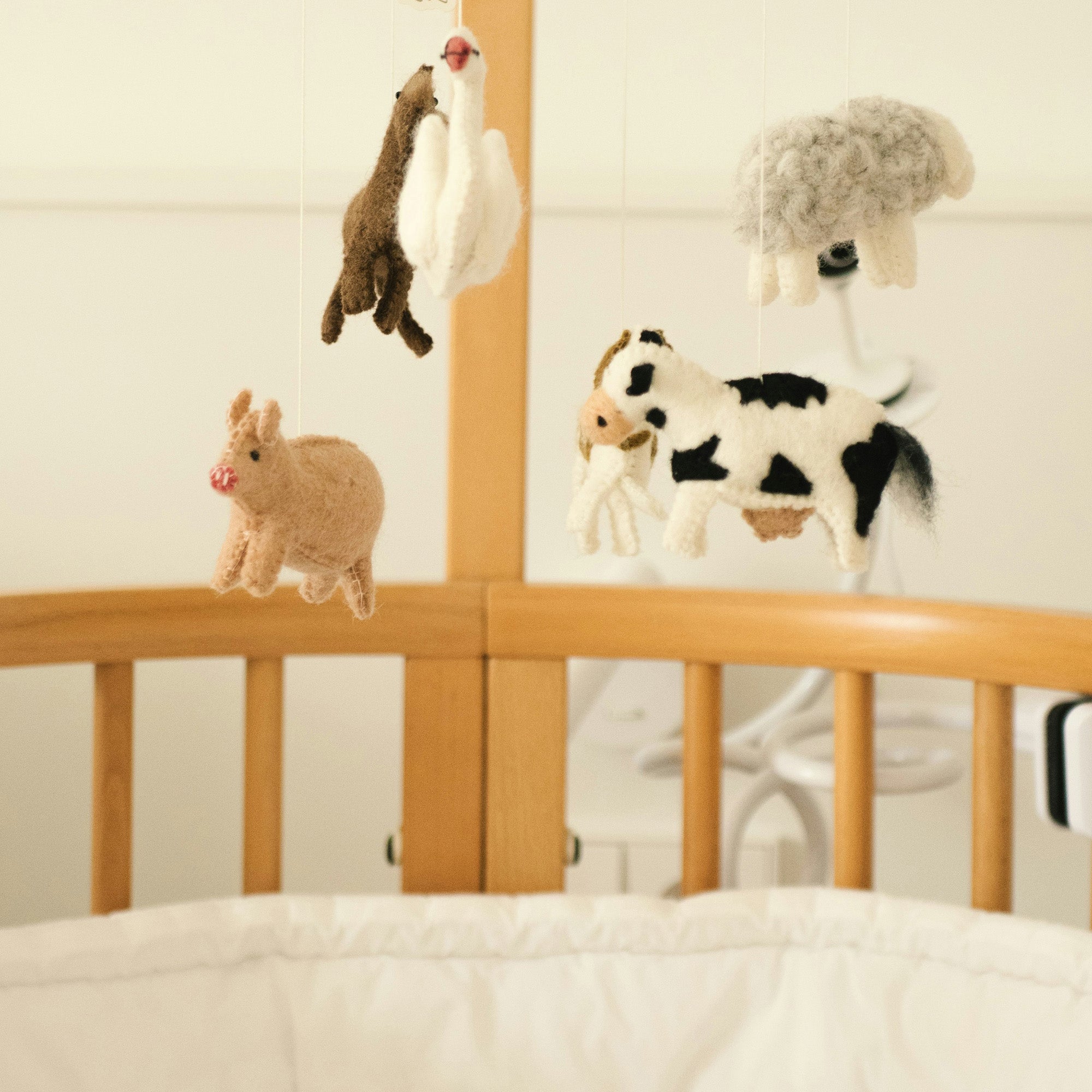 top of baby crib with an animal themed mobile