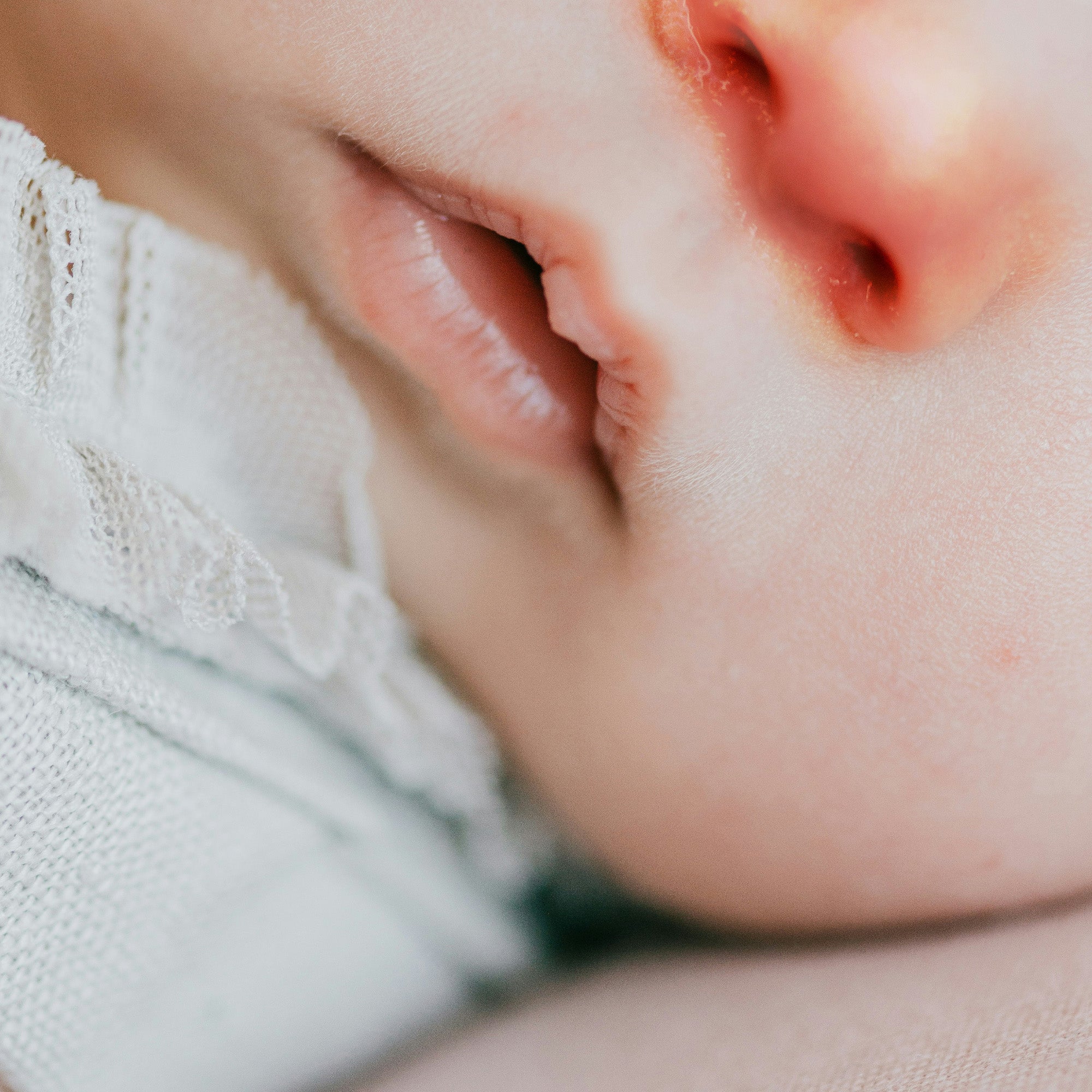 Close up of baby's face with stuffy red nose