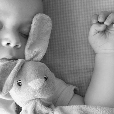 black and white image of baby sleeping