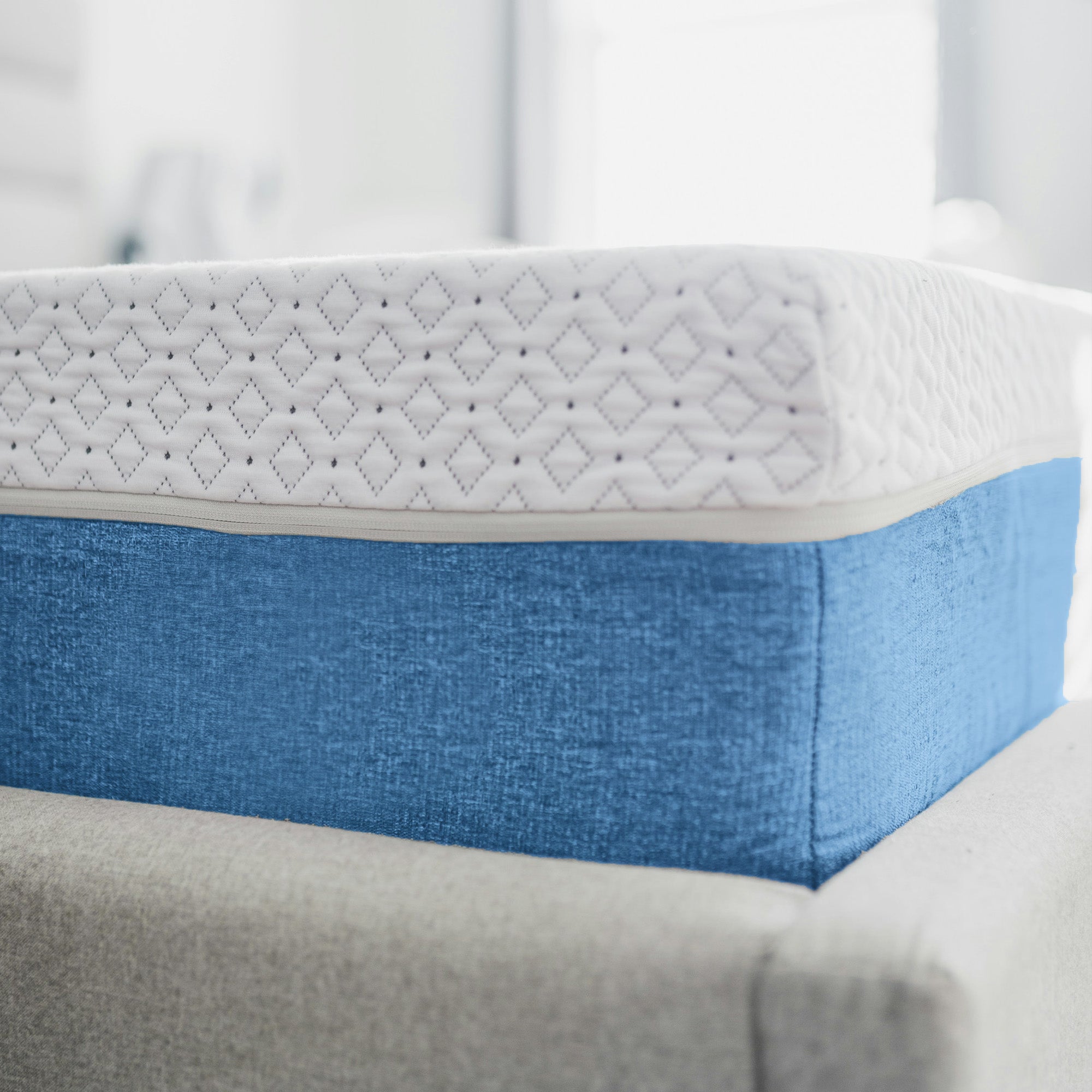 Corner of a blue memory foam mattress