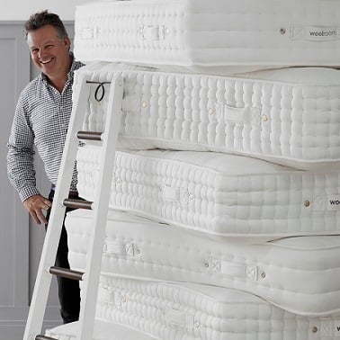 Chris with stack of mattresses