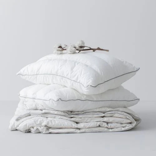 Is Polyester Too Hot for Sleeping? - Stack of pillows and duvet