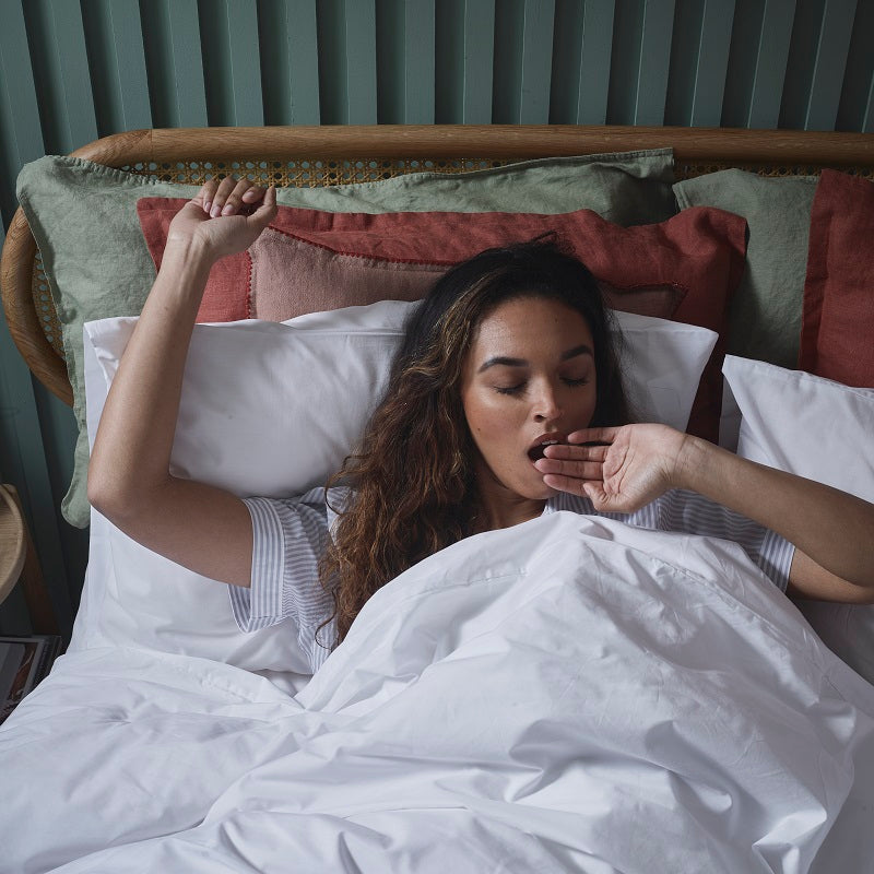Woman yawning in woolroom bed