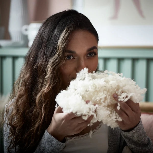 woman smelling the wool
