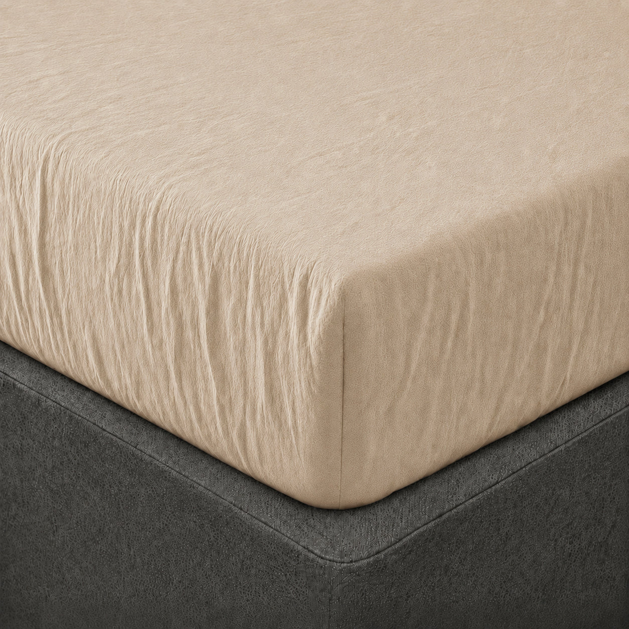 A close up of the corner of a mattress with Woolroom's Mariana Linen Blend Fitted Sheet in Sand.