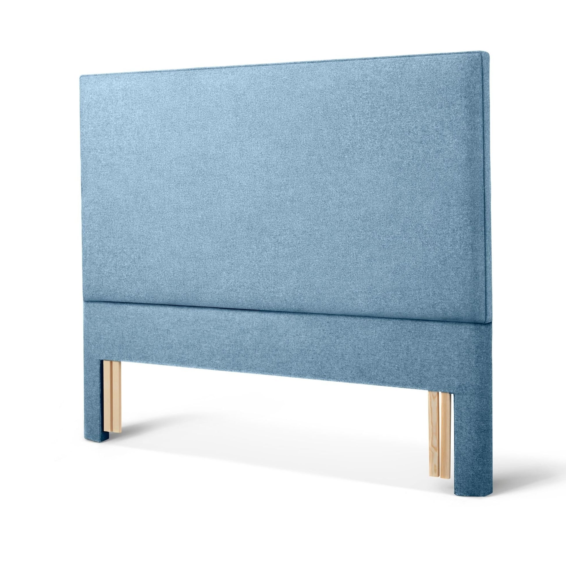 The Woolroom Broadway Floor Standing Headboard in Juniper light blue upholstery can be added seamlessly to a bed.