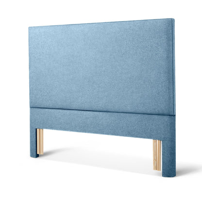 The Woolroom Broadway Floor Standing Headboard in Juniper light blue upholstery can be added seamlessly to a bed.