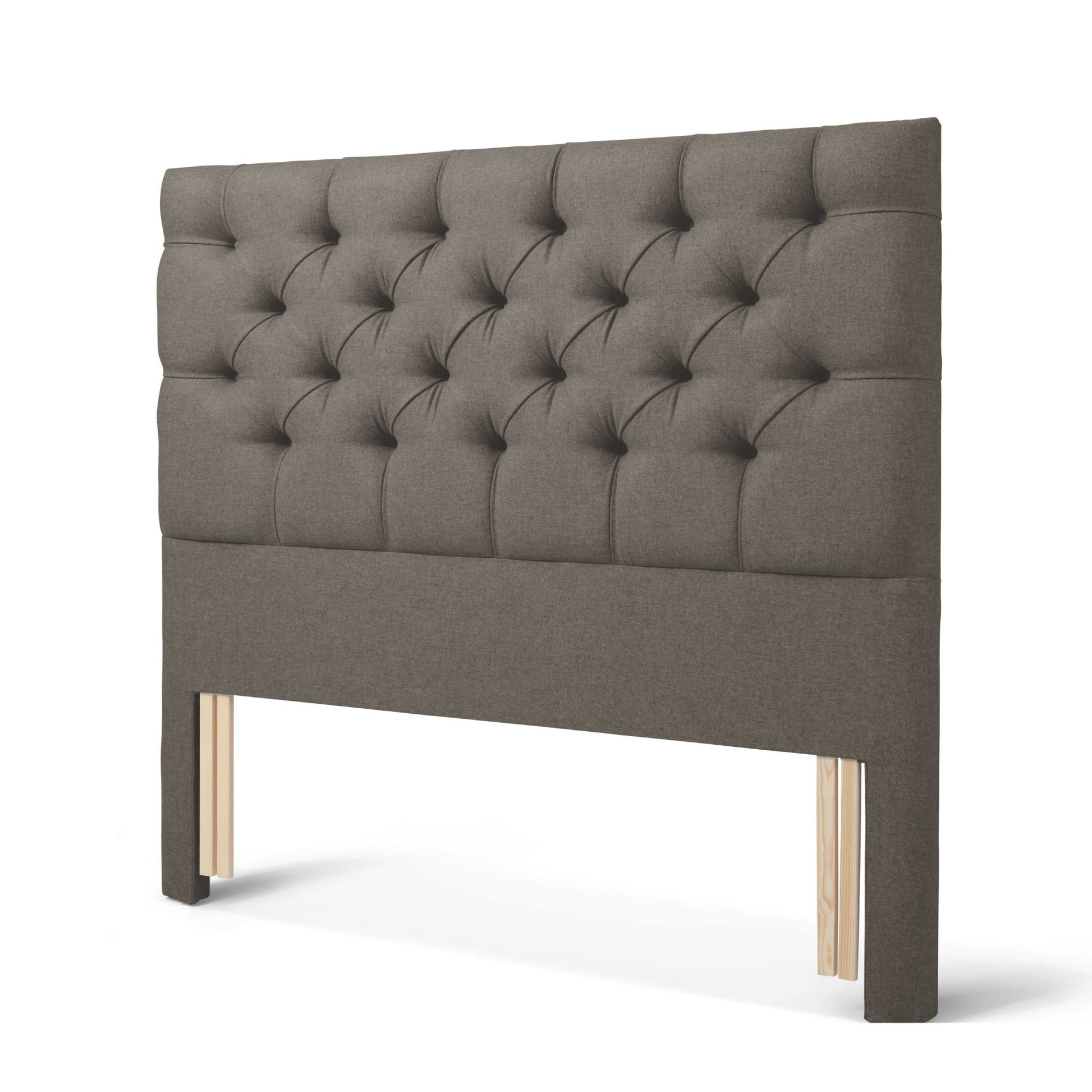 The Woolroom Nuffield Floor Standing Headboard in Dark Grey has a traditional British buttoning for a tufted design.