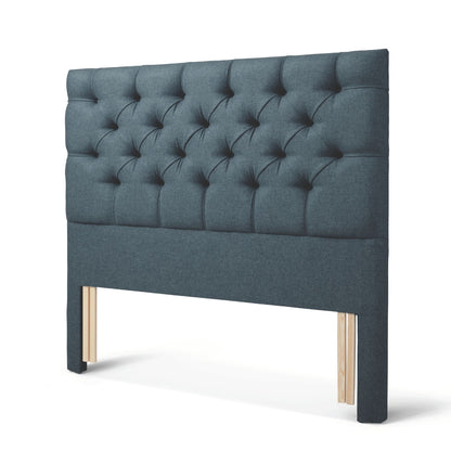 The Woolroom Nuffield Floor Standing Headboard in Hemlock blue has a traditional British buttoning for a tufted design.