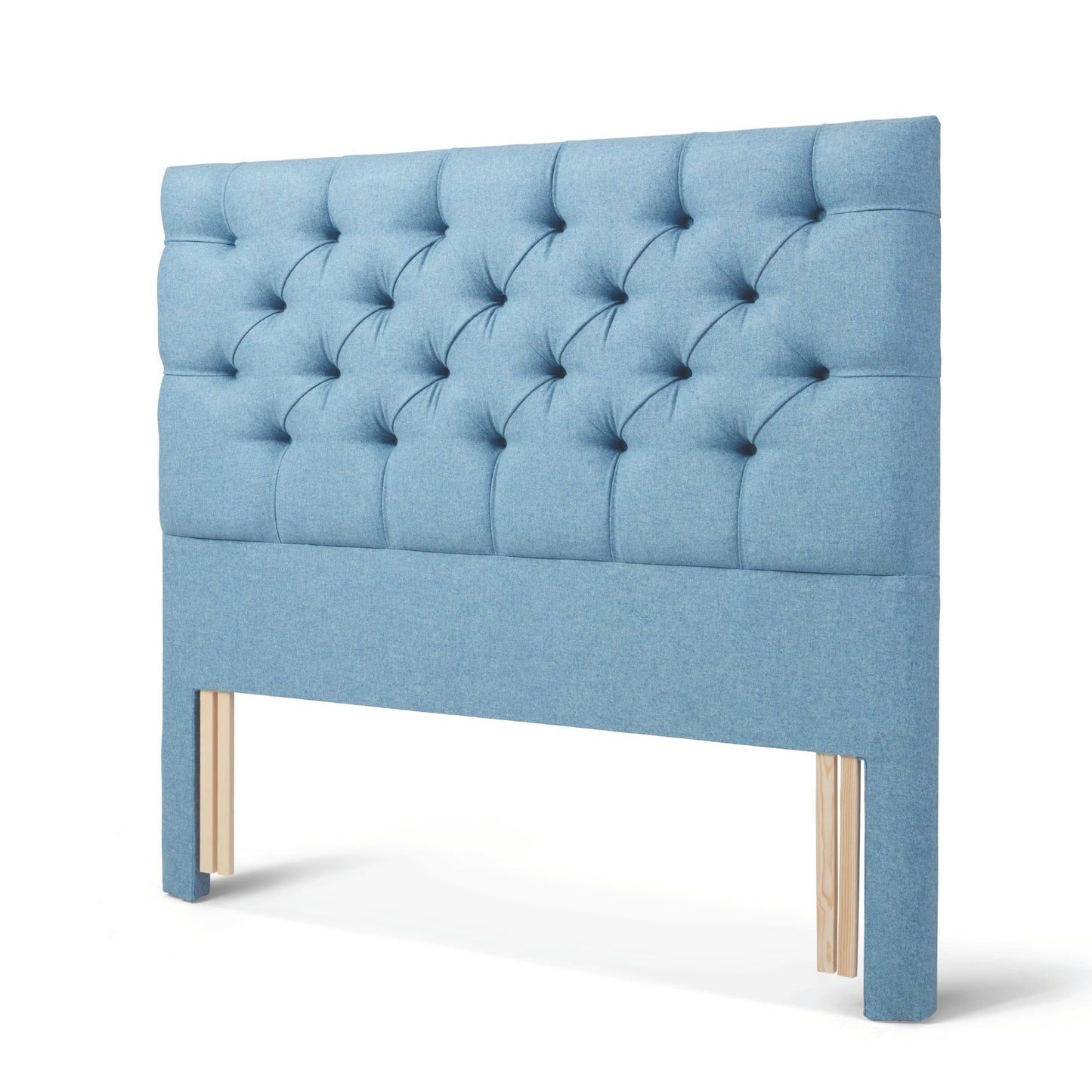 The Woolroom Nuffield Floor Standing Headboard in Juniper light blue has a traditional British buttoning for a tufted design.