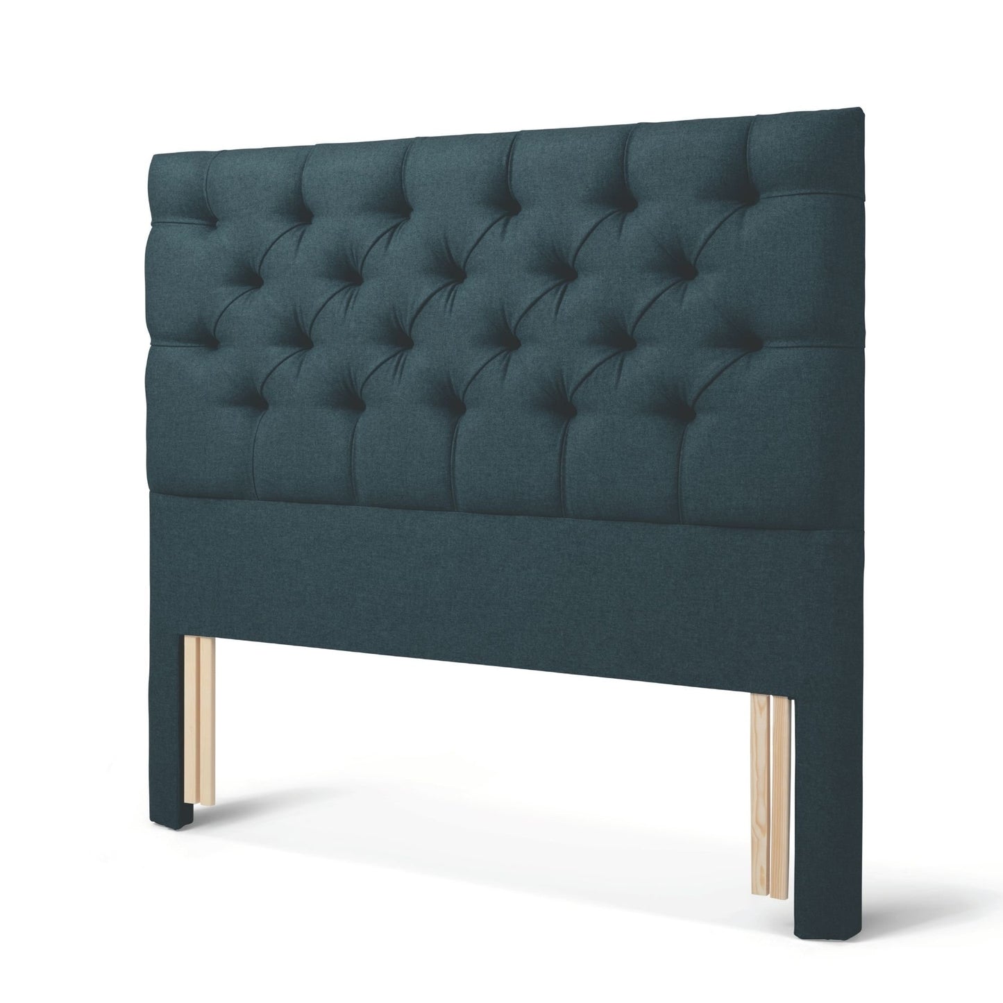 The Woolroom Nuffield Floor Standing Headboard in Pine dark green has a traditional British buttoning for a tufted design.