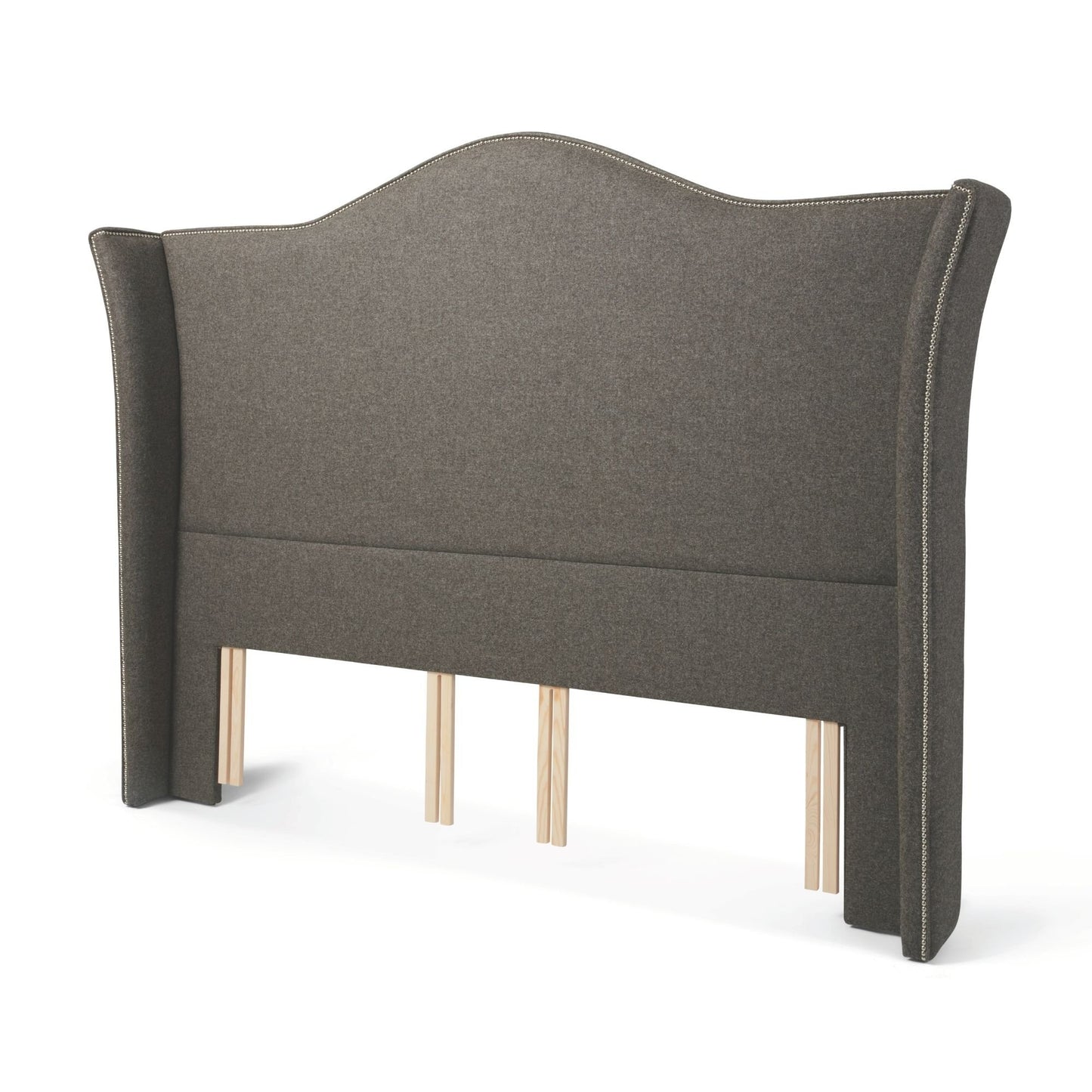 The Stoneywell Floor Standing Headboard in dark grey upholstery is a grand design with wings and nailhead trim.