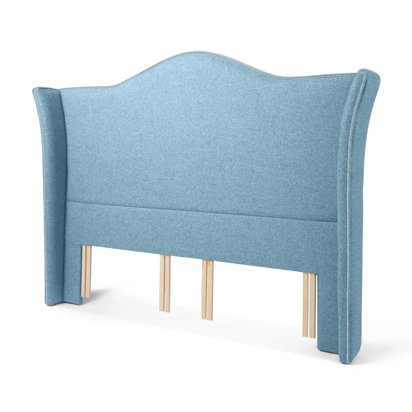 The Stoneywell Floor Standing Headboard in Juniper light blue upholstery is a grand design with wings and nailhead trim.