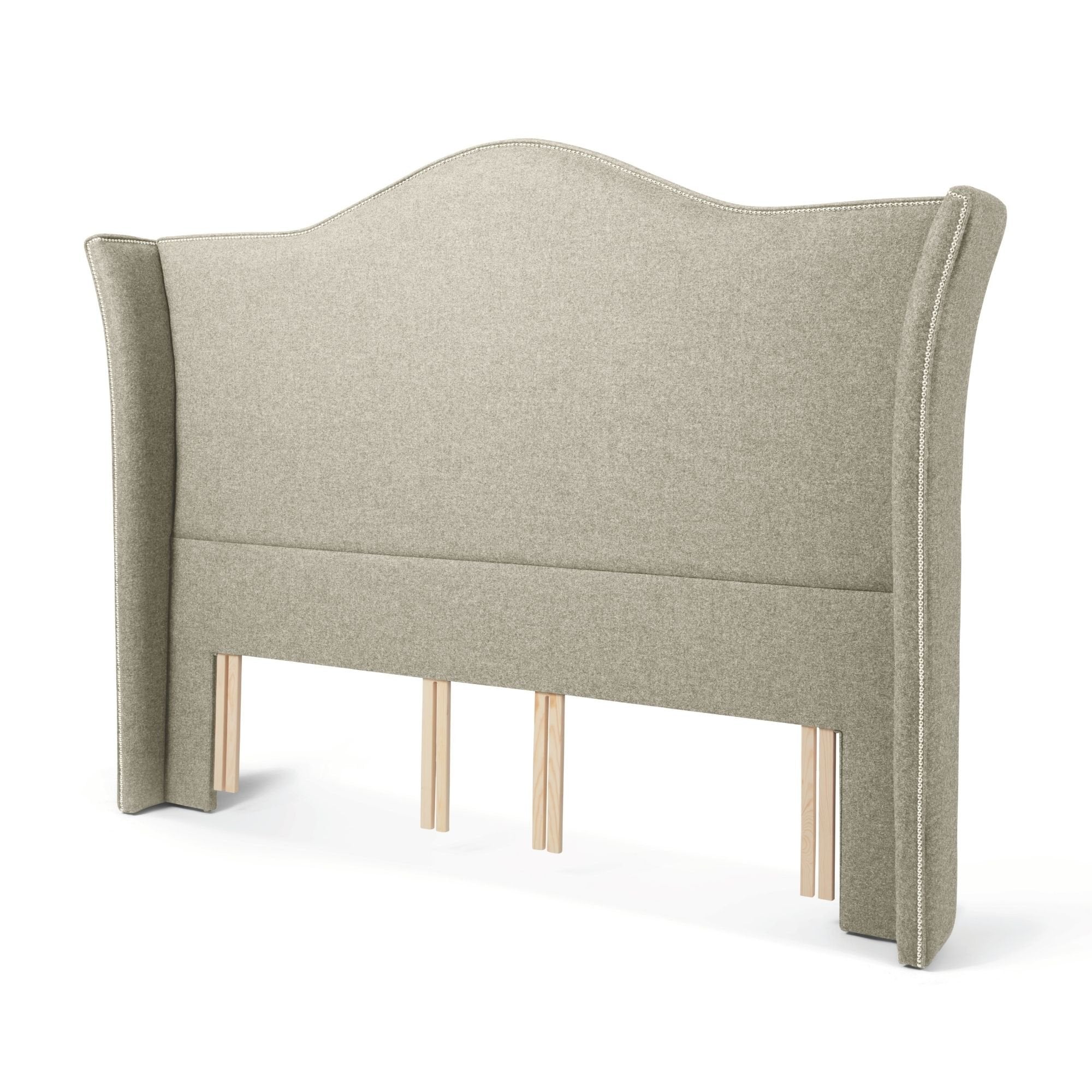 The Stoneywell Floor Standing Headboard in Light Grey upholstery is a grand design with wings and nailhead trim.
