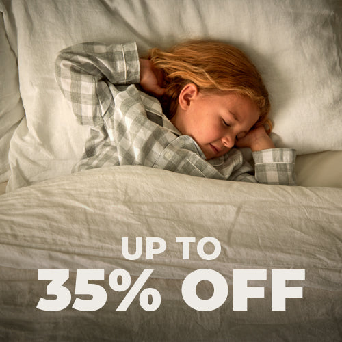 Image of a green Woolroom kids label sewn into the edge of a kids pillow