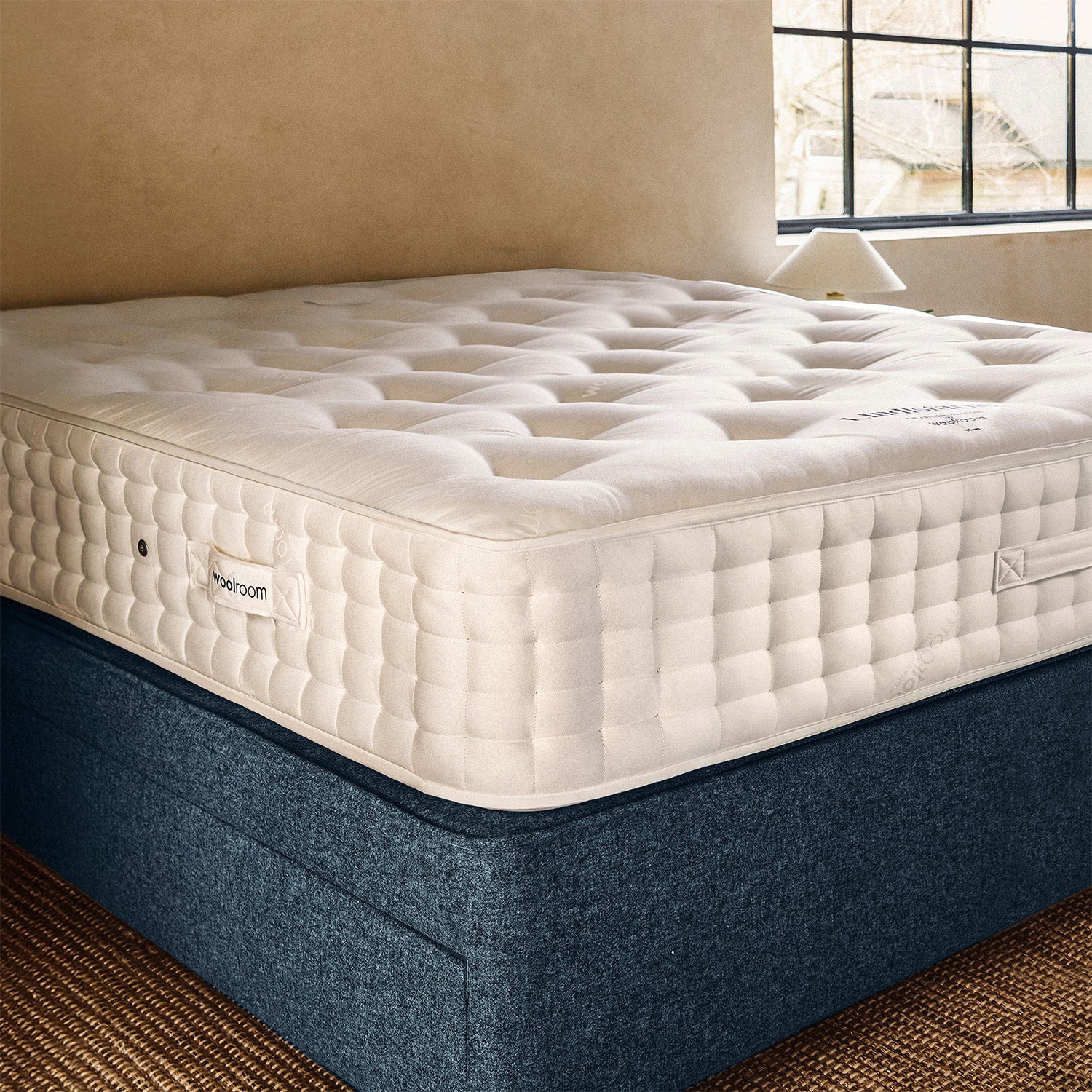 The side view of the Lindisfarne wool mattress with the tufting and layers of wool encased inside.