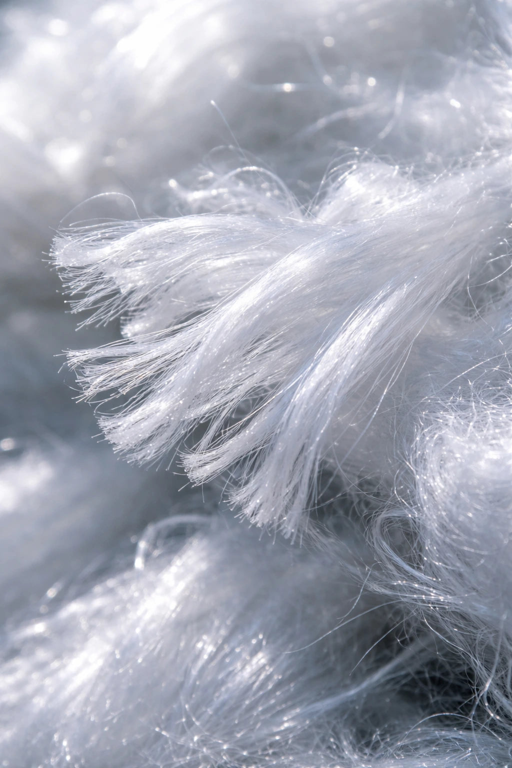 Close-up of white fibers against a blurred gray background