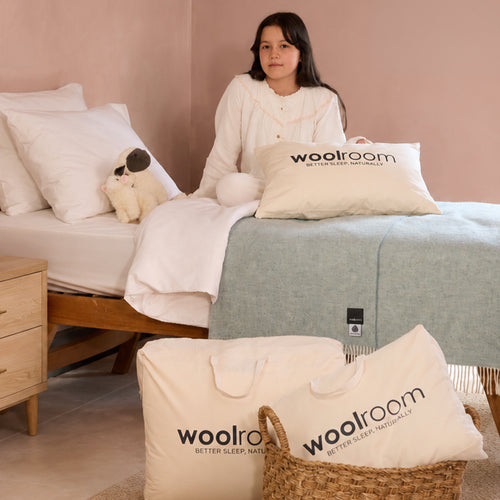Image of a green Woolroom kids label sewn into the edge of a kids pillow