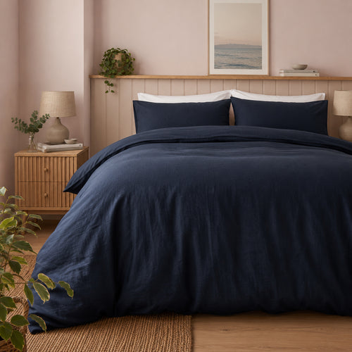woman in navy blue linen bed
