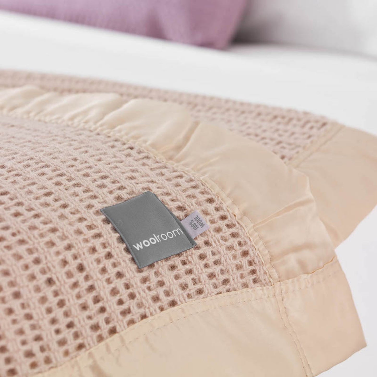 The Woolroom Ribblesdale Cellular Wool Bed Blanket in the color Mocha has a breathable open weave texture with a satin edge.