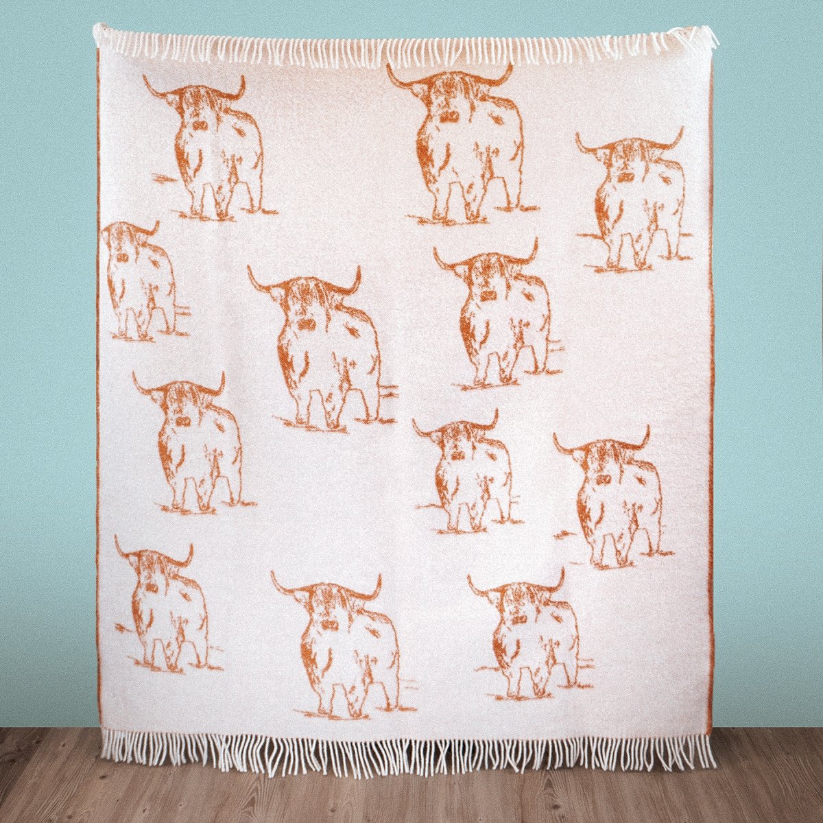 Close-up of Wild and Wool Highland Coo Wool Throw - Rust by Woolroom – sustainable wool throws 