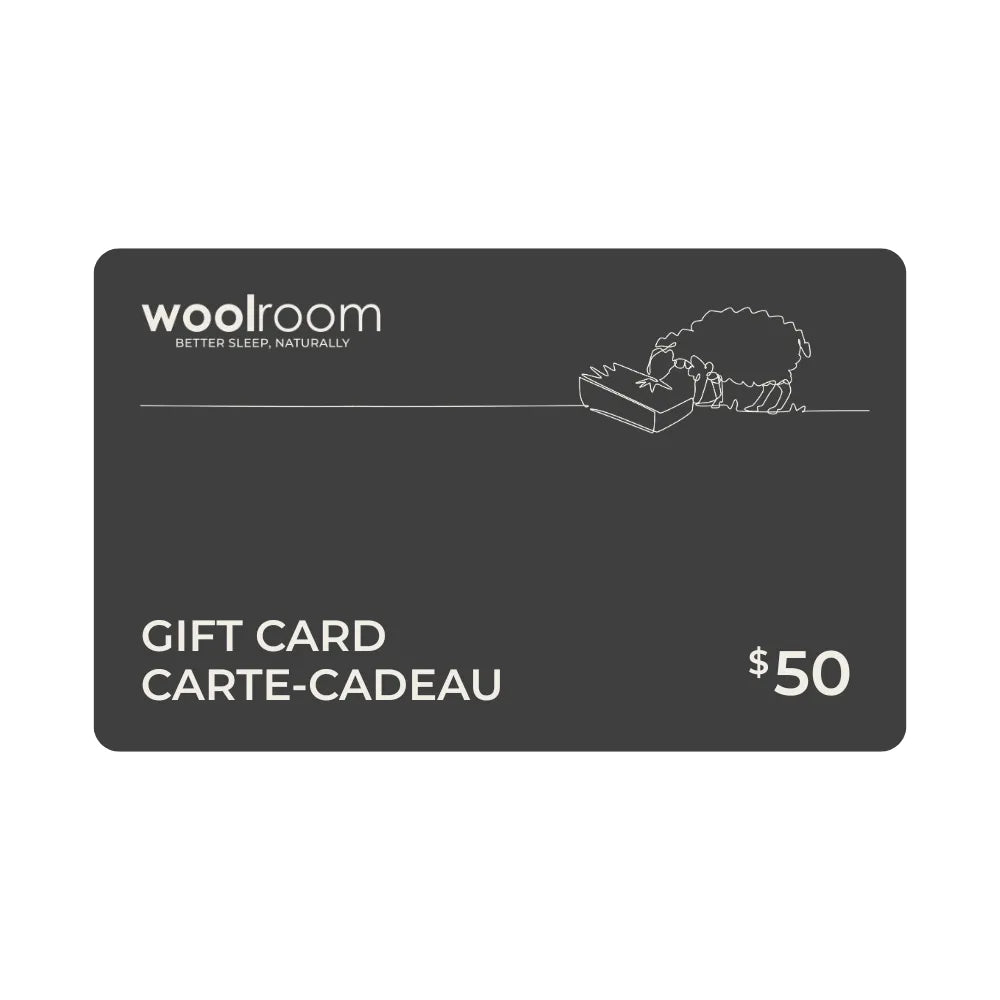 A 50 dollar Woolroom gift card on a solid white background. The card is dark gray with white text and a minimalist line drawing of a sheep.
