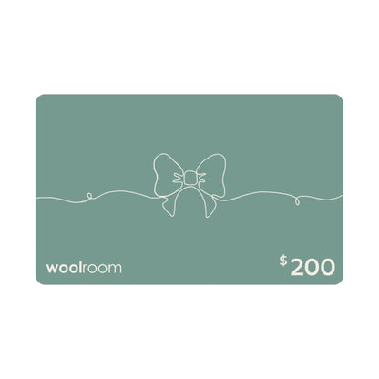 A $200 Woolroom gift card in a muted sage green color, featuring a minimalist white line art bow design in the center, with the 'woolroom' brand name on the bottom left and '$200' on the bottom right.