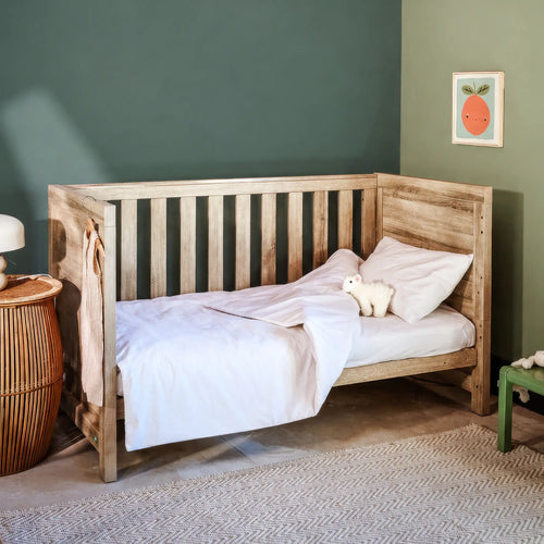 Image of a green Woolroom kids label sewn into the edge of a kids pillow