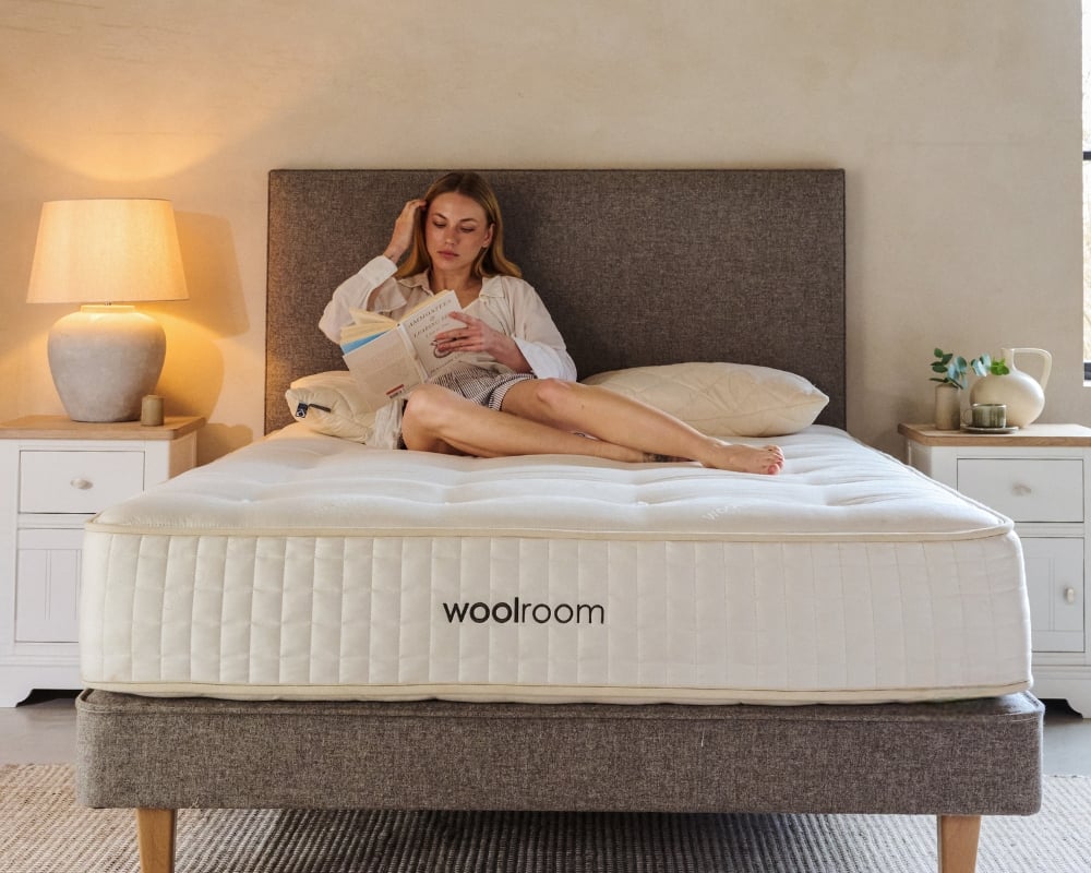 Woman lying on a woolroom mattress in a bedroom