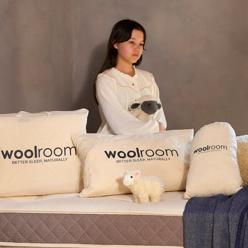 Image of a green Woolroom kids label sewn into the edge of a kids pillow