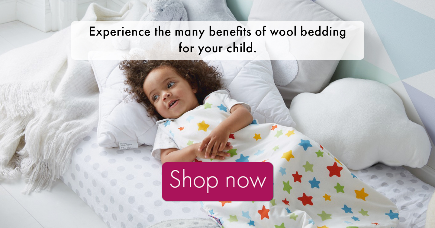 child in a baby sleeping bag with a link to discover wool bedding for your child