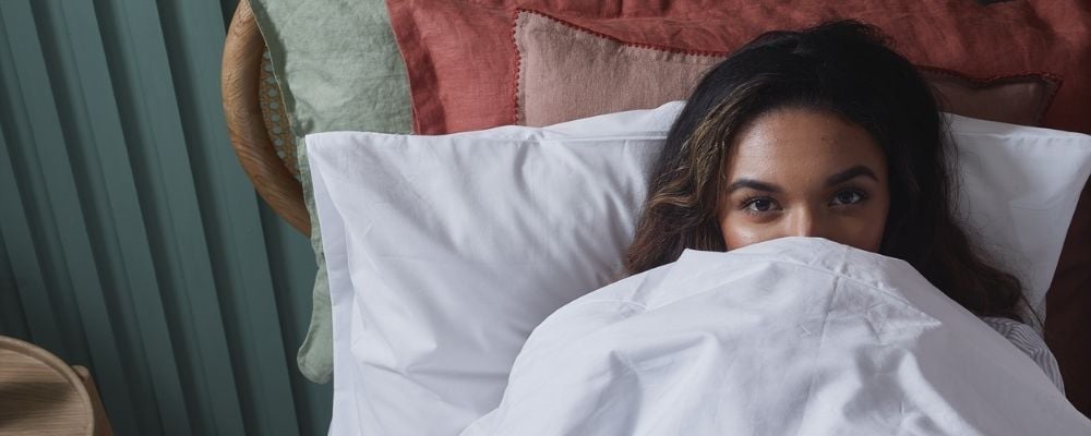 woman warm in bed with a wool duvet