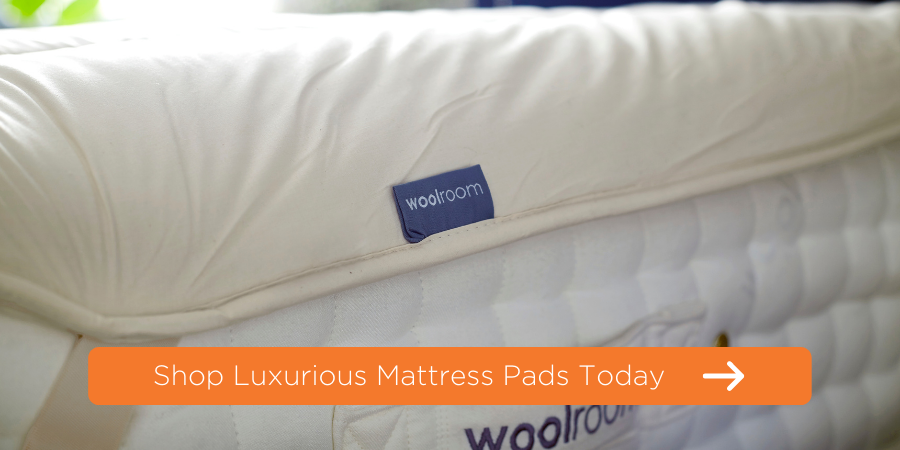 wool mattress pad on top of mattress